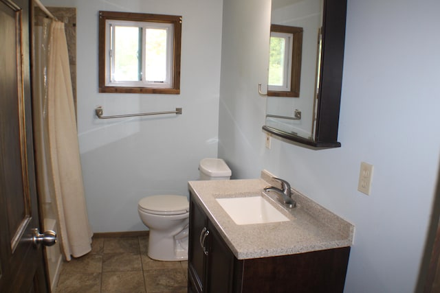 bathroom with a shower with curtain, tile patterned flooring, vanity, and toilet