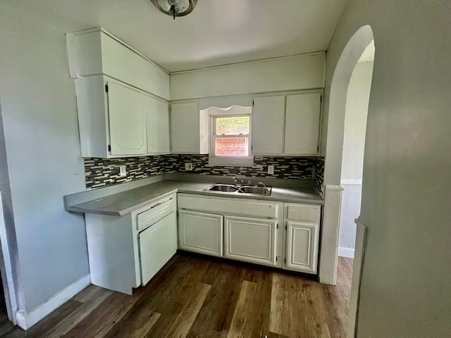 kitchen featuring decorative backsplash, white cabinetry, dark hardwood / wood-style flooring, and sink