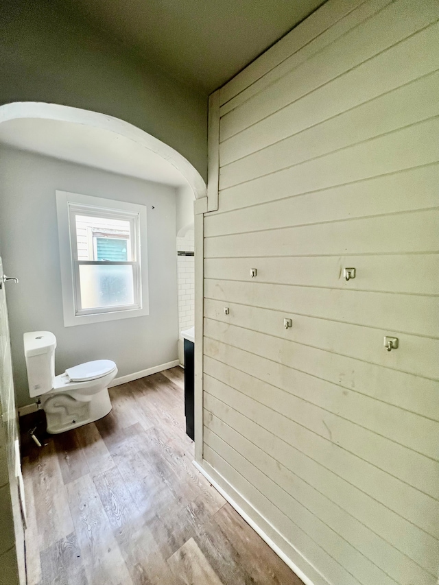 bathroom with wood-type flooring and toilet