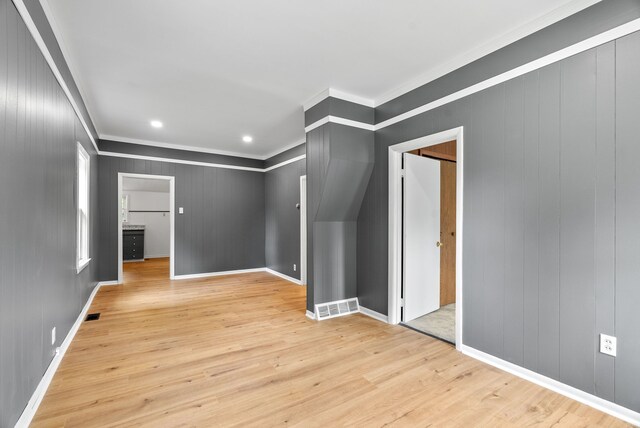1114 Church St, Port Huron, MI 48060 - spare room featuring crown molding, light wood-style floors, baseboards, wood walls, and recessed lighting