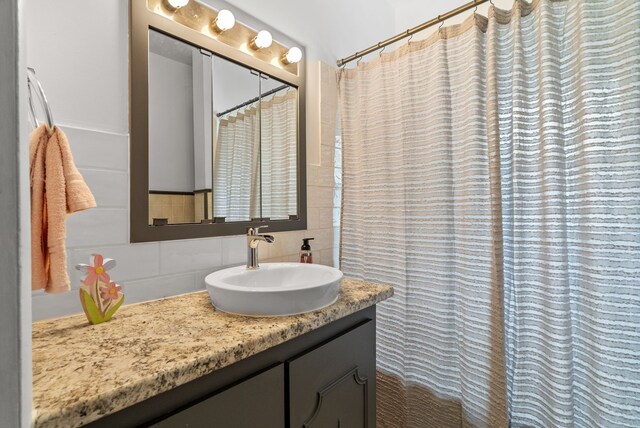 1114 Church St, Port Huron, MI 48060 - bathroom with backsplash, vanity, and curtained shower