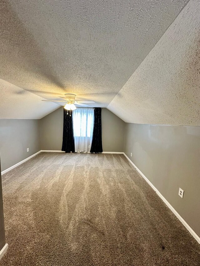 11675 Forrer St, Detroit, MI 48227 - additional living space with a textured ceiling, carpet, baseboards, lofted ceiling, and a ceiling fan