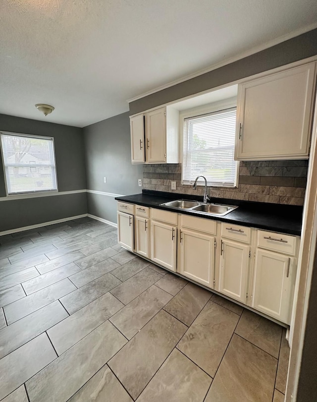 11675 Forrer St, Detroit, MI 48227 - kitchen with a sink, backsplash, dark countertops, and plenty of natural light