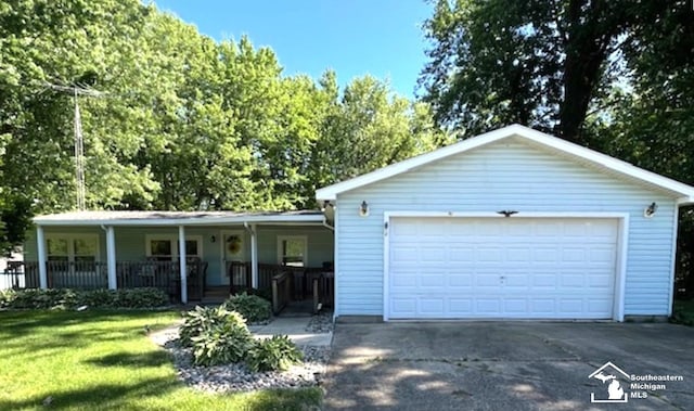 single story home featuring a garage, covered porch, and a front yard