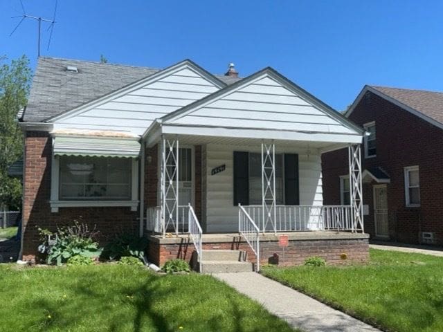 14141 Rossini Dr, Detroit, MI 48205 - bungalow-style home with covered porch and a front lawn