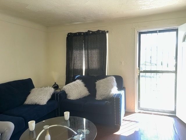 living room featuring a textured ceiling and hardwood / wood-style flooring