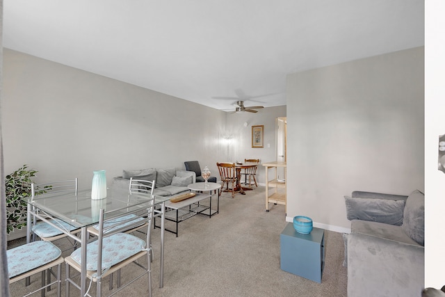 carpeted living room with ceiling fan