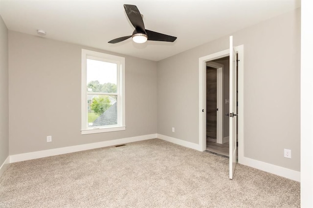 unfurnished bedroom with ceiling fan and light colored carpet