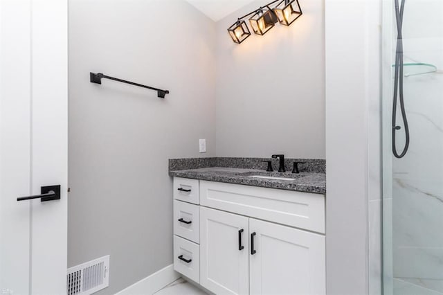 bathroom with vanity and a shower