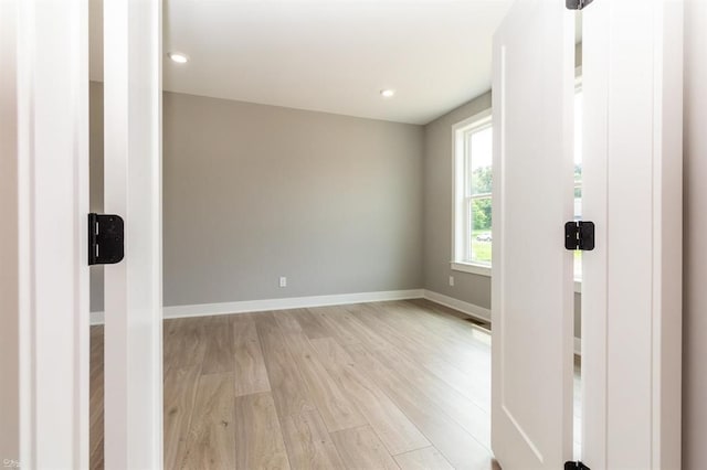 spare room featuring light wood-type flooring