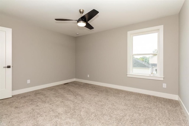 empty room with light carpet and ceiling fan