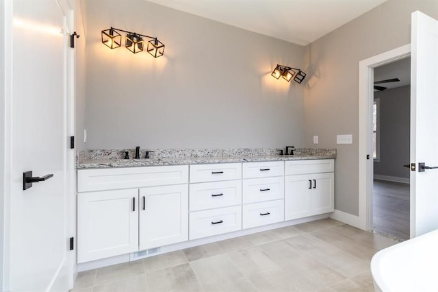 bathroom featuring tile patterned flooring and vanity