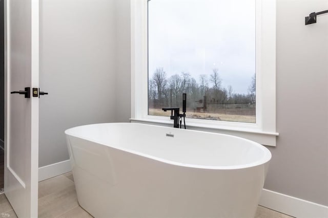 bathroom featuring tile patterned floors and a bathing tub