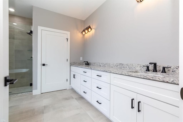 bathroom with a shower with door and vanity