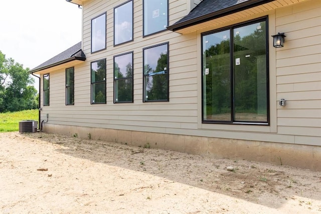 view of side of home featuring central AC unit