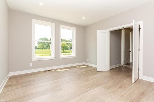 spare room featuring light hardwood / wood-style flooring