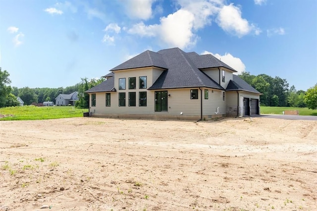 back of property with a garage