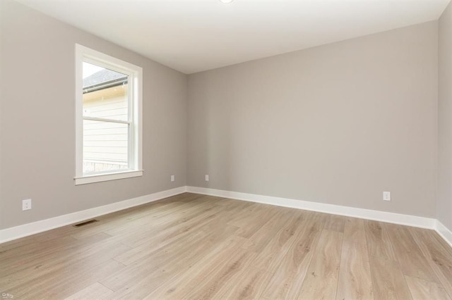 spare room with light hardwood / wood-style floors