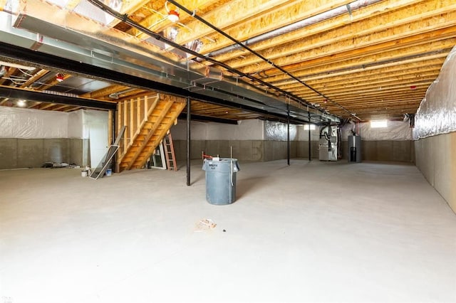 basement featuring heating unit and water heater