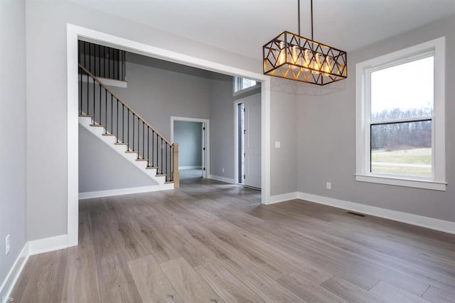 unfurnished dining area featuring hardwood / wood-style floors