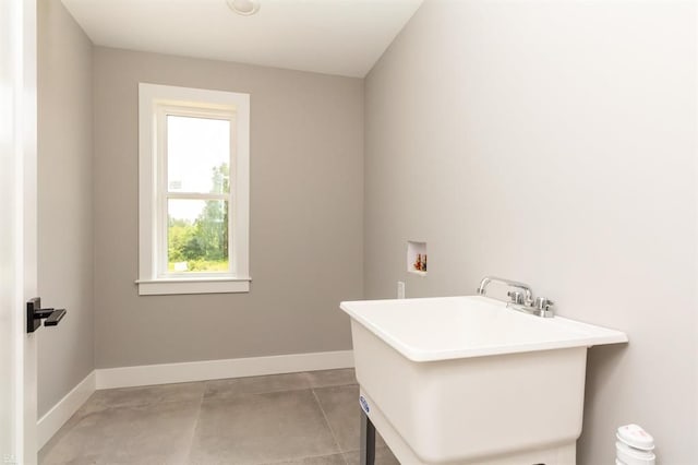 laundry area featuring tile patterned flooring, hookup for a washing machine, and sink