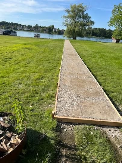 view of community featuring a water view and a yard