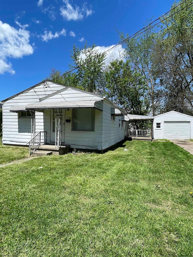 view of front facade with a garage, an outdoor structure, and a front yard