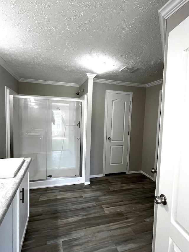 2759 Naples Ct, Lapeer, MI 48446 - bathroom featuring a shower stall, wood finished floors, vanity, baseboards, and a textured ceiling