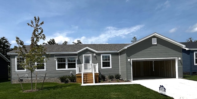 view of front of home with a garage and a front yard