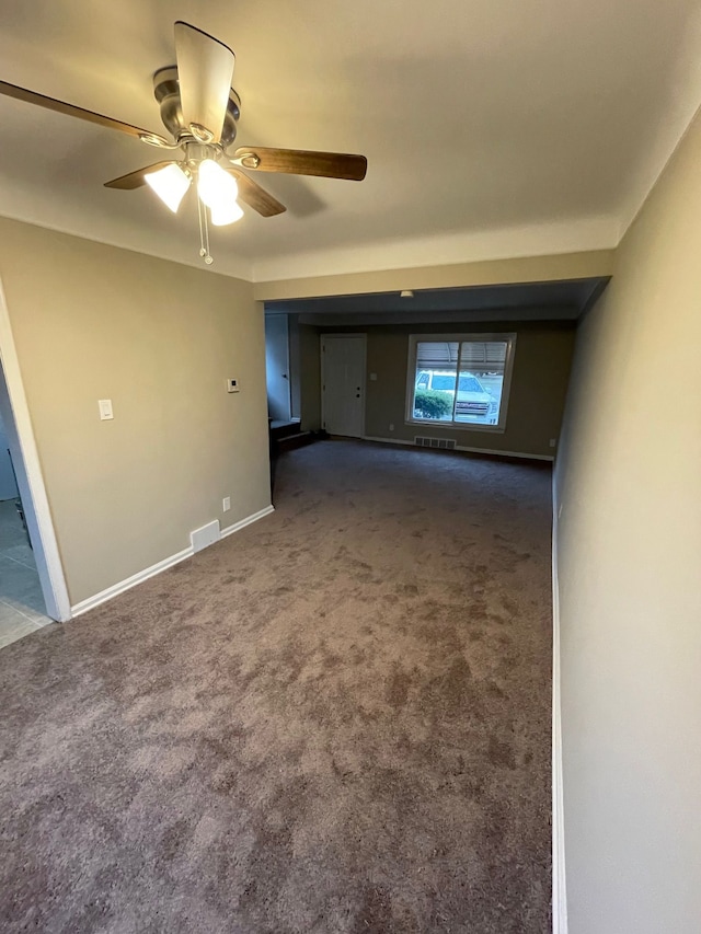 carpeted spare room with ceiling fan