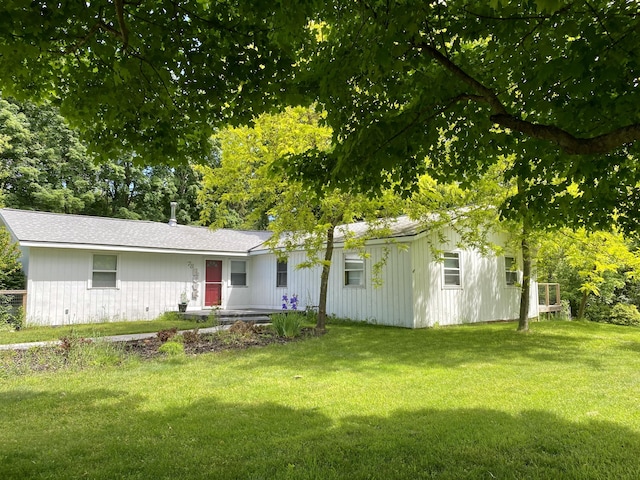 view of front of house with a front lawn and central air condition unit