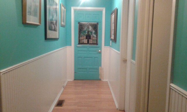227 Joliet Ave, Houghton Lake, MI 48629 - corridor with a wainscoted wall and light wood finished floors
