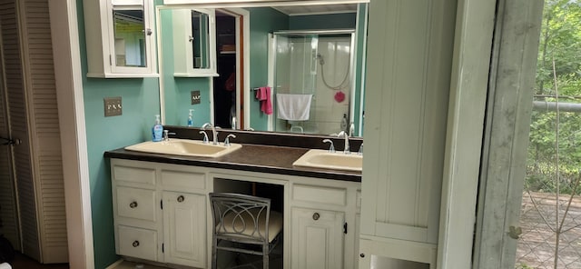 bathroom with vanity and a shower with door