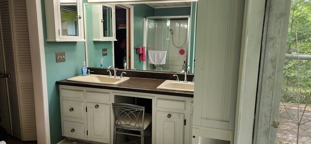 227 Joliet Ave, Houghton Lake, MI 48629 - bathroom featuring a closet and double vanity
