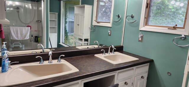227 Joliet Ave, Houghton Lake, MI 48629 - full bathroom featuring double vanity and a stall shower