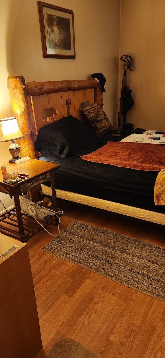 bedroom with wood-type flooring