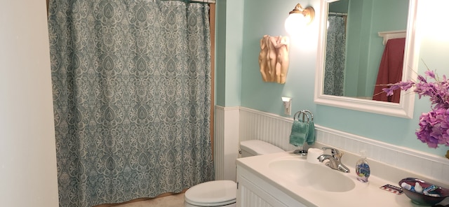 bathroom with walk in shower, vanity, and toilet