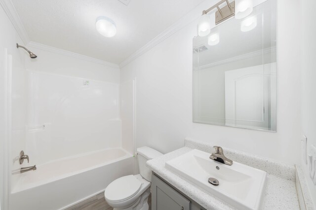 full bathroom with washtub / shower combination, crown molding, wood-type flooring, toilet, and vanity