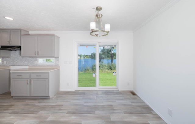2769 Naples Ct, Lapeer, MI 48446 - kitchen featuring gray cabinetry, extractor fan, a chandelier, backsplash, and light wood-style flooring
