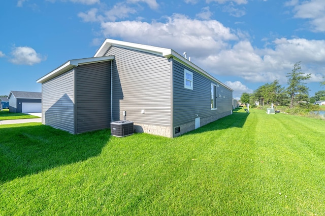 view of property exterior with a yard and central AC