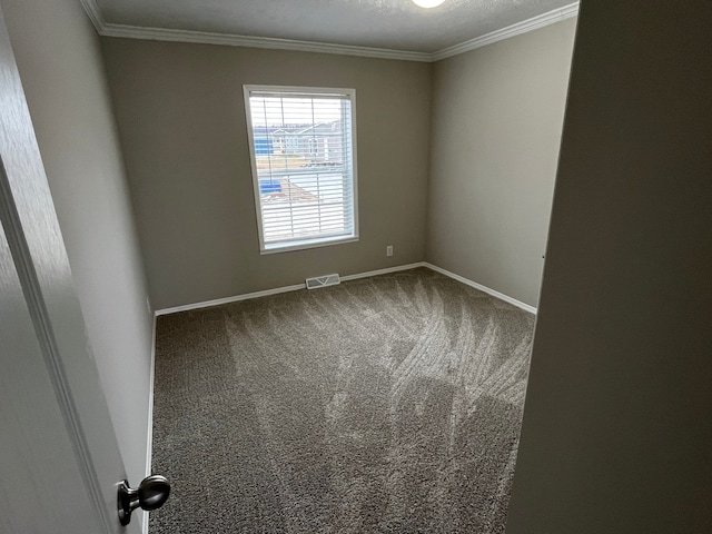 carpeted empty room with a textured ceiling and crown molding