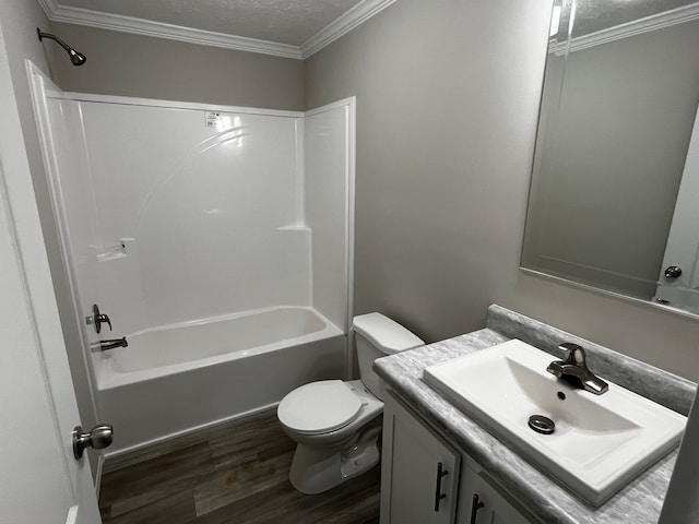 full bathroom featuring shower / bathtub combination, vanity, crown molding, wood-type flooring, and toilet