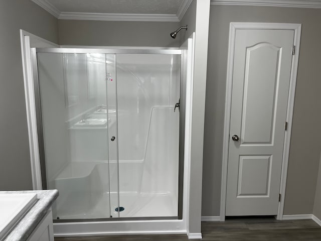 2765 Naples Ct, Lapeer, MI 48446 - full bathroom featuring a stall shower, vanity, baseboards, crown molding, and wood finished floors