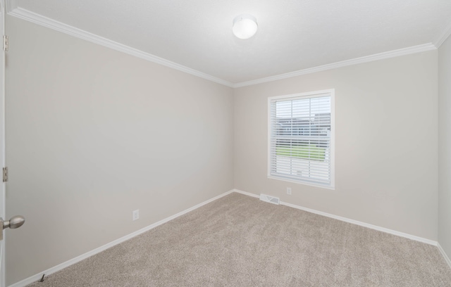 spare room featuring crown molding and light carpet