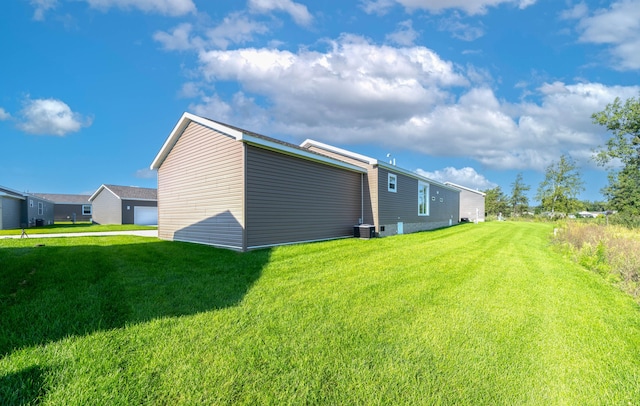 exterior space featuring a yard and central AC