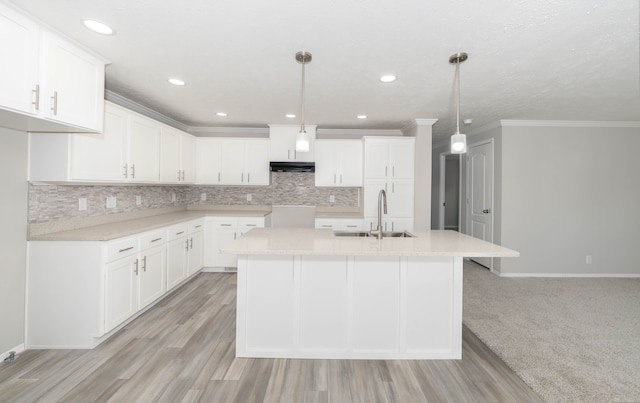 kitchen featuring light hardwood / wood-style floors, sink, and hanging light fixtures