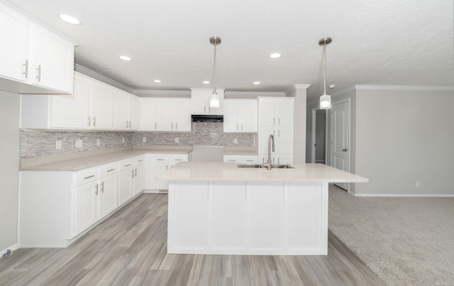 2756 Naples Ct, Lapeer, MI 48446 - kitchen with a sink, under cabinet range hood, baseboards, an island with sink, and ornamental molding