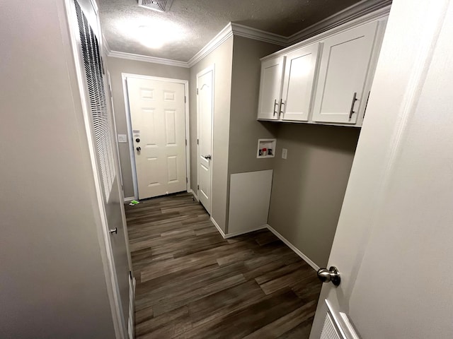 laundry area featuring hookup for a washing machine, crown molding, dark hardwood / wood-style flooring, and cabinets