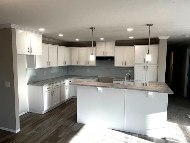 2760 Naples Ct, Lapeer, MI 48446 - kitchen featuring under cabinet range hood, white cabinetry, decorative backsplash, recessed lighting, and ornamental molding
