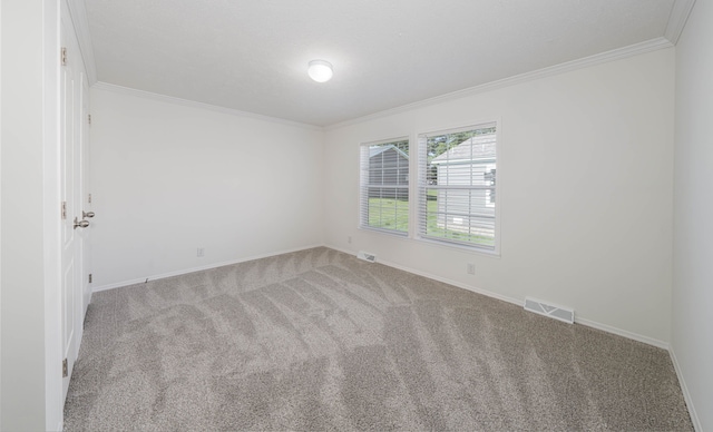 empty room with light colored carpet and crown molding